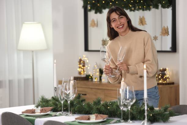 istock Smiling woman setting table for Christmas celebration at home. Space for text 2177344398