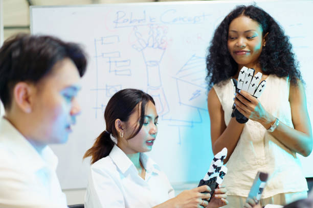 istock University students are discussing about the robotic project. 2177345874