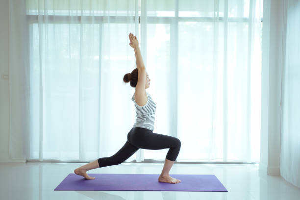 istock Asian woman practices yoga exercise at home. 2177346003