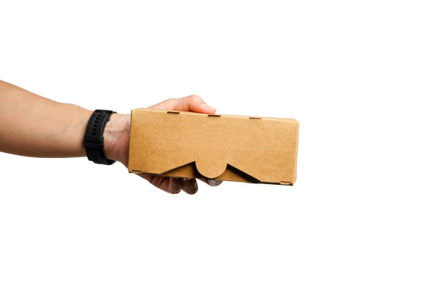 istock Hand holding a brown cardboard box with a recycling sign on a white background.Ideas for choosing recycled boxes,cardboard box for delivery on a white background 2177349083