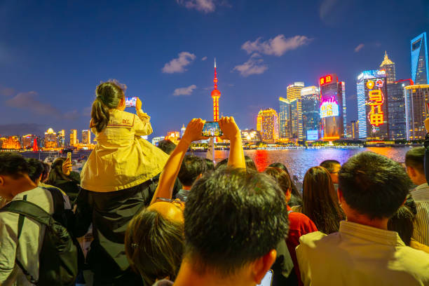 Night photo of skyline in Shanghai with a group of people
