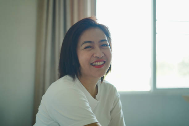 istock Woman smiles and laughs happily on the bed. 2177351347