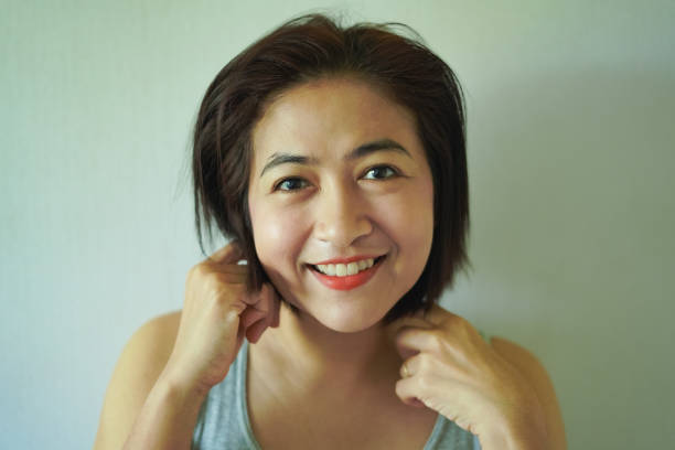 Take a close-up photo of a woman's face, feeling smiling.