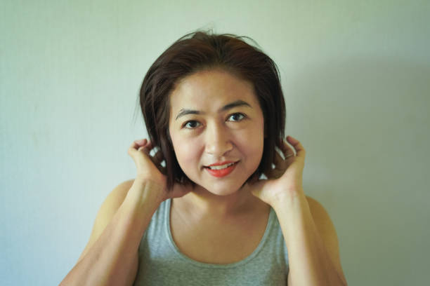 Take a close-up photo of a woman's face, feeling smiling.