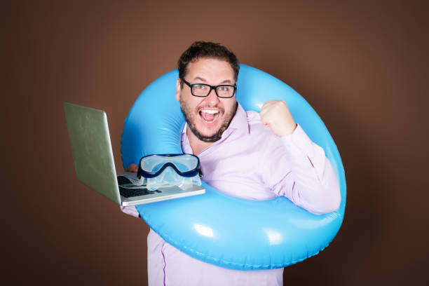 istock Funny fat man with an inflatable ring is going on vacation. 2177352038