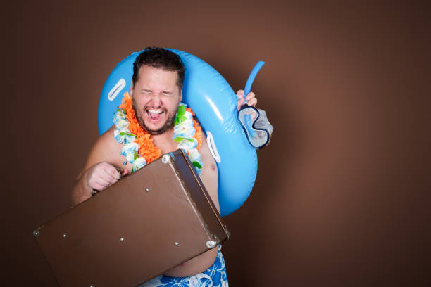 istock Funny fat man with an inflatable ring is going on vacation. 2177352072