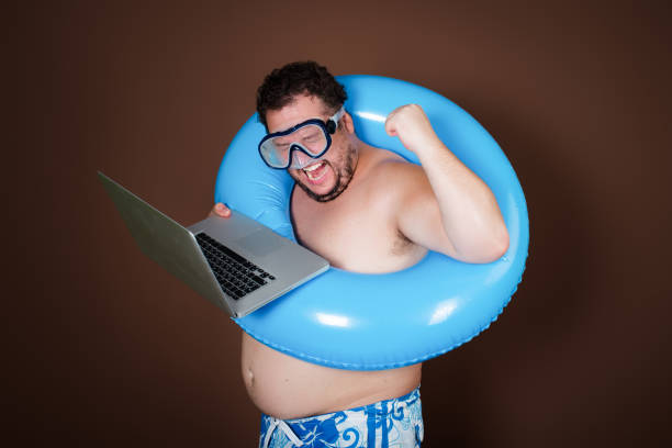 istock Funny fat man with an inflatable ring is going on vacation. 2177352200
