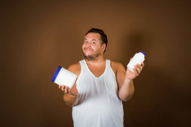 istock Problems with excess weight. Fat man with a big belly. 2177352755