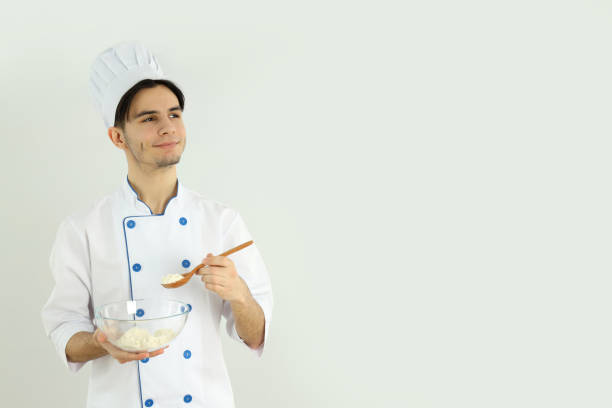 istock Concept of cooking, young man chef on light background 2177356284