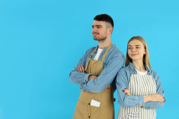 istock Young waiter and waitress on blue background 2177358868