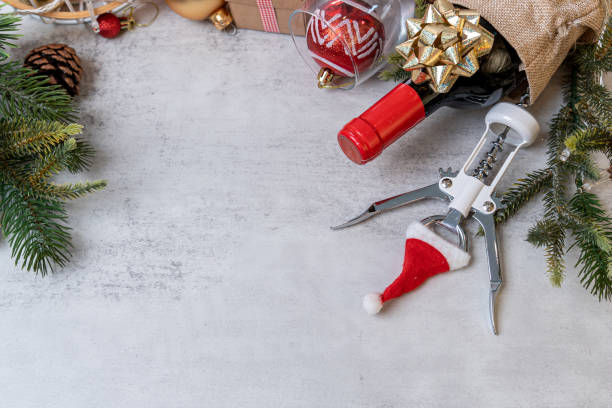 istock Christmas Red wine and wine opener with santa hat decoration on table background. 2177359089