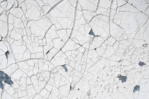 istock White steel wall with obvious cracks. Rusted metal background with peeling paint 2177359614