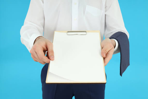 istock Waiter man holds blank clipboard on blue background 2177360144