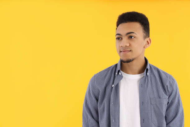 istock Young man in checkered shirt on yellow background 2177361709
