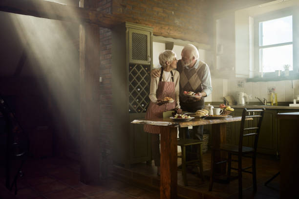 istock Embraced senior couple talking in the kitchen. 2177362326