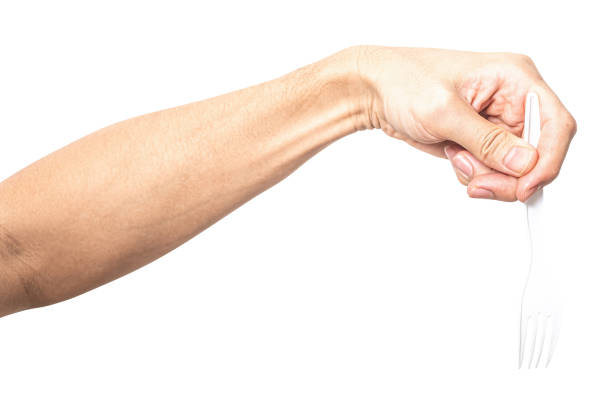 Male hand holding a white plastic fork isolated on white background with clipping path.