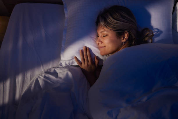 istock Above view of smiling woman sleeping in bed. 2177363283