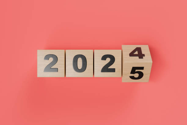 istock Wooden cubes changing from 2024 to 2025 on a red background 2177363531