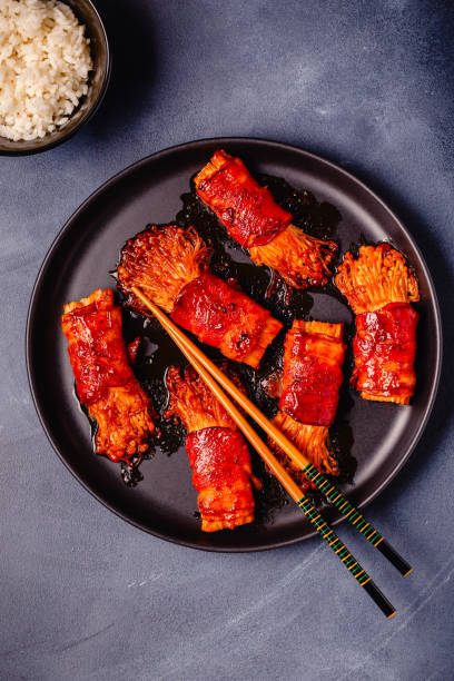 istock Bacon roll with enoki mushroom grilled with sauce. 2177367803