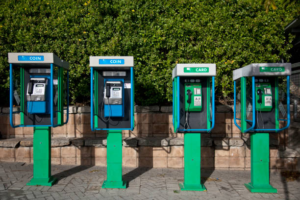 Horizontal view of a row of four colorful vintage telephone booth in Cape Town