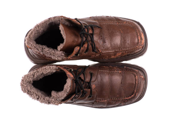 Vintage brown leather boots isolated on white background.