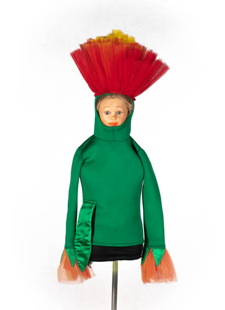 A little girl standing besides and holding a large paper cache puppet called a Mojiganga - which are very popular in Mexico at parties nd celebrations and weddings. They are big enough for people to be inside them, dancing and walking about.