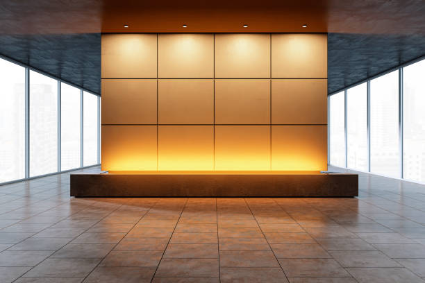 istock Modern exhibition space with a central backlit display wall in a cityscape background. 3D Rendering 2177369334