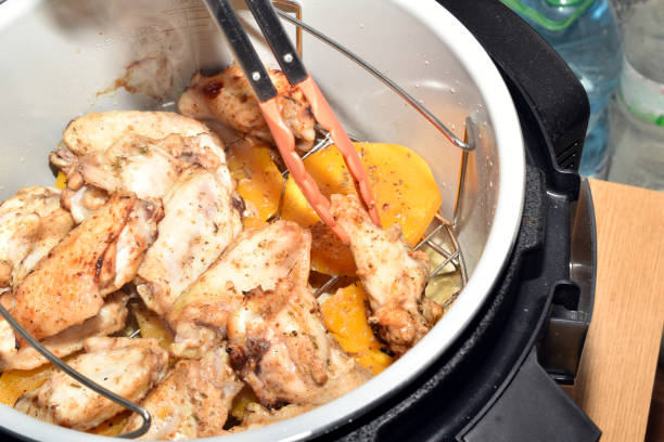 istock Chicken wings are turned over with tongs. 2177370807