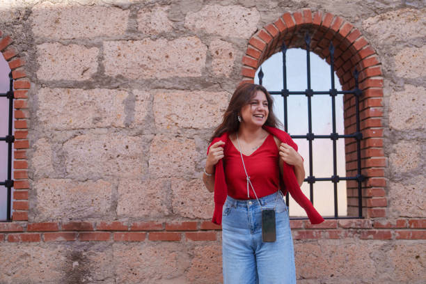 istock Young woman standing in front of a Islamic architectural stone wall. 2177371711