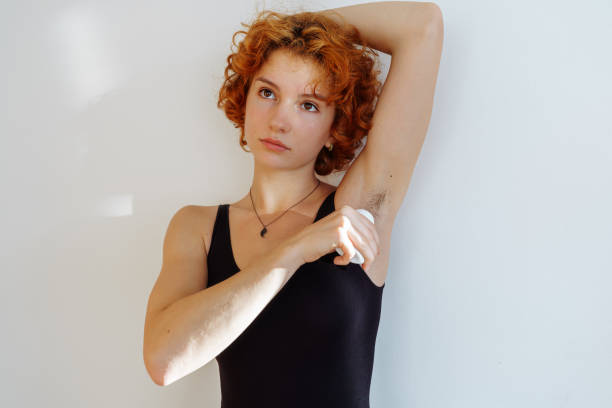 istock young woman uses hygiene product, roll-on deodorant 2177372610