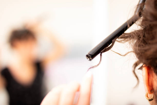 istock Young woman curling long hair 2177376280