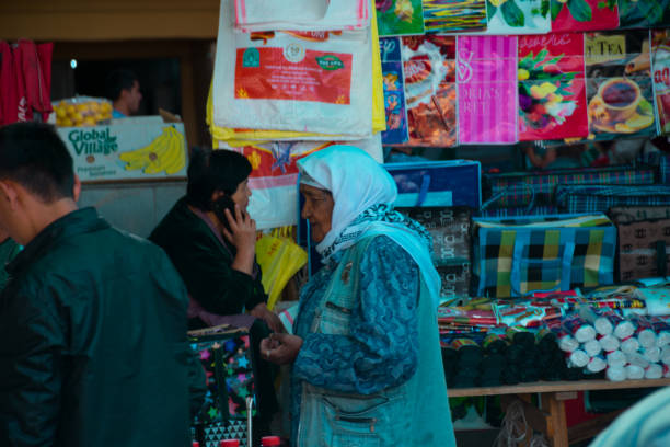 Samarkand,Uzbekistan;September,18,2024:women trying to sell their products at a bustling market in Samarkand, Uzbekistan, an important city along the historic Silk Road. The women are offering a variety of goods, including fresh produce, handmade crafts, and traditional items, in an energetic and vibrant marketplace. The market has long been a cultural and economic hub, showcasing the rich trading history of Samarkand.