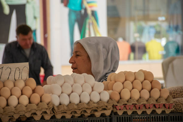 Samarkand,Uzbekistan;September,18,2024: women trying to sell their products at a bustling market in Samarkand, Uzbekistan, an important city along the historic Silk Road. The women are offering a variety of goods, including fresh produce, handmade crafts, and traditional items, in an energetic and vibrant marketplace. The market has long been a cultural and economic hub, showcasing the rich trading history of Samarkand.