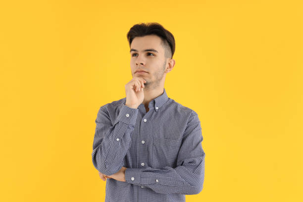 istock Attractive guy in shirt on yellow background 2177377328
