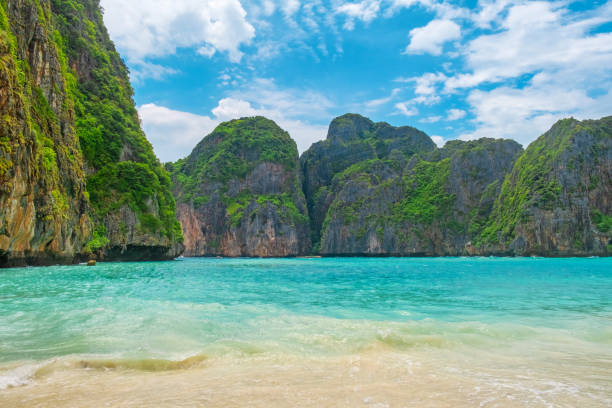 istock Maya Bay tropical sandy beach with turquoise water ocean on Phi Phi islands, Krabi, Thailand with nobody. Empty beach, surrounded by towering green cliffs under bright blue sky 2177378504