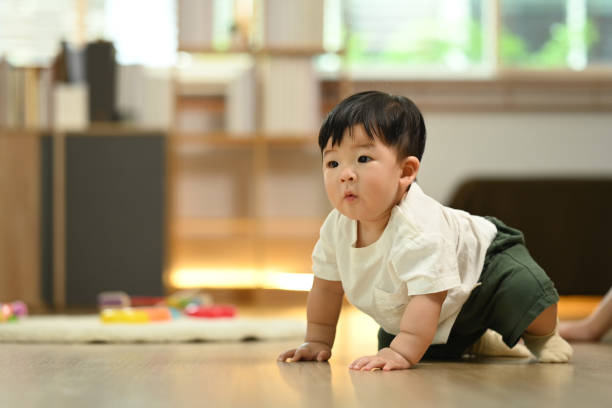 istock Cute little baby boy having fun crawling on floor. Child development concept 2177381390