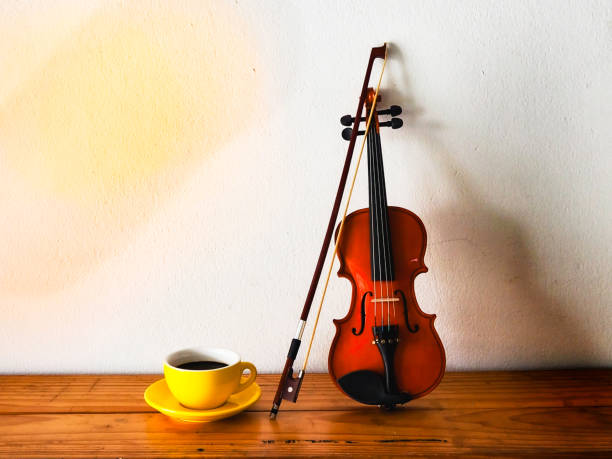 istock Yellow ceramic Coffeecup put beside violin and bow, 2177381986