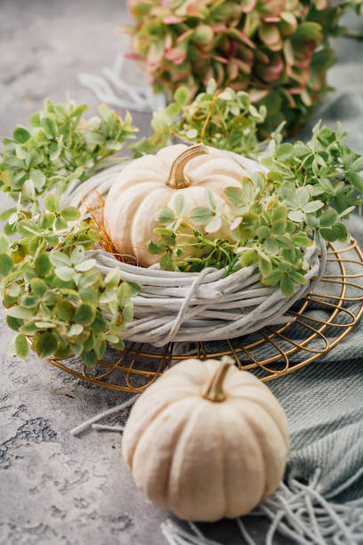 istock Table decoration with wreath and white pumpkins on kitchen table for Thanksgiving and Halloween 2177382816