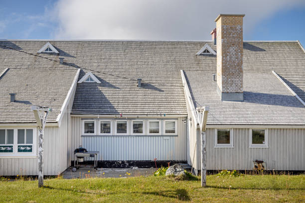 Nuuk, Godthåb, Greenland, Denmark - August 18th 2024:  Modern residential building with traditional clotheslines on a lush lawn in the front