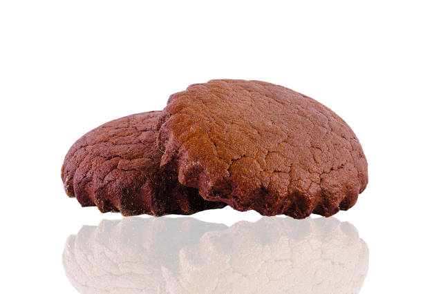 Two chocolate brownie cakes are laying on top of each other on a white background