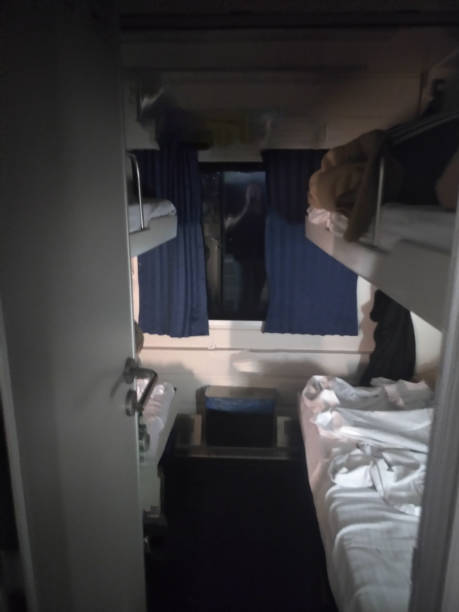istock Train cabin with bunk beds, curtains, and window in a sleeper compartment. 2177387276