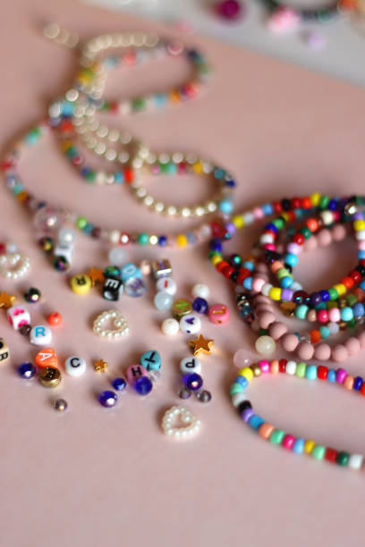 istock Colorful Bracelets, Necklaces And Beads On Pink Background 2177389601