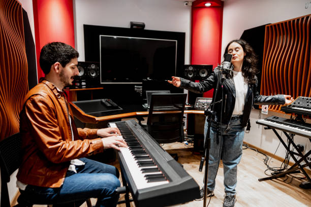 istock Young man playing synthesizer and musician friend singing at music studio 2177391706