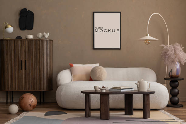 istock Creative composition of aesthetic living room interior with mock up poster frame, boucle sofa, wooden sideboard, coffee table, marble lamp, brown wall and personal accessories. Home decor. Template. 2177392562
