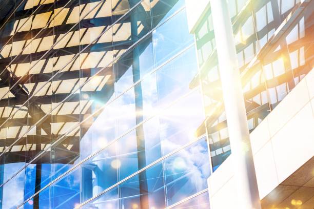 istock A modern skyscraper facade with a glass wall reflecting the blue sky and clouds. 2177392996