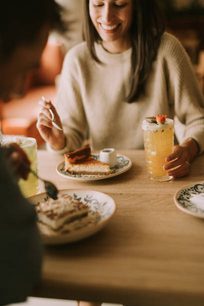 istock Enjoying dessert together in a cozy cafe while sharing laughter and delightful conversation on a sunny afternoon 2177393029
