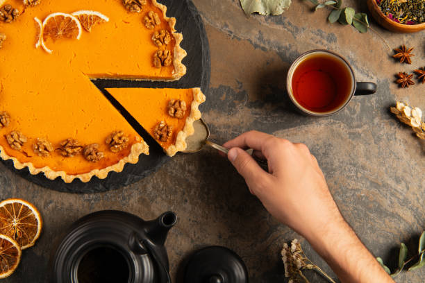 Celebrating Thanksgiving with a festive table filled with pumpkin pie and warm drinks