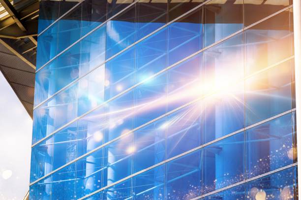 Sunlight shines through a modern glass building.