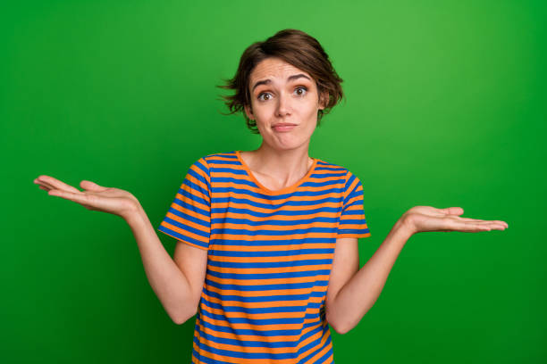 istock Portrait of charming clueless person shrug shoulders arms hold empty space solution isolated on green color background 2177395694