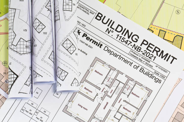 istock APPROVED BUILDINGS PERMIT CONCEPT in buildings activity with approved residential building project, imaginary cadastral map and General Urban Plan 2177398058